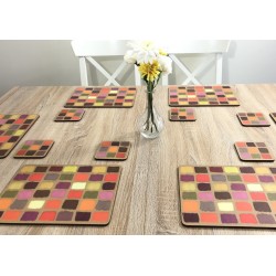 Wooden dining table. Corkbacked funky placemats colourful Harlequin pattern.