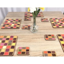 Wooden table setting. Corkbacked funky placemats colourful Harlequin pattern.