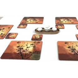 Sunset design cork backed table mats by Plymouth Pottery against white tablecloth